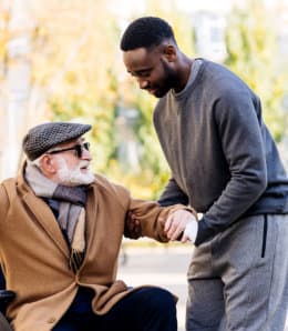 male caregiver assisting senior man