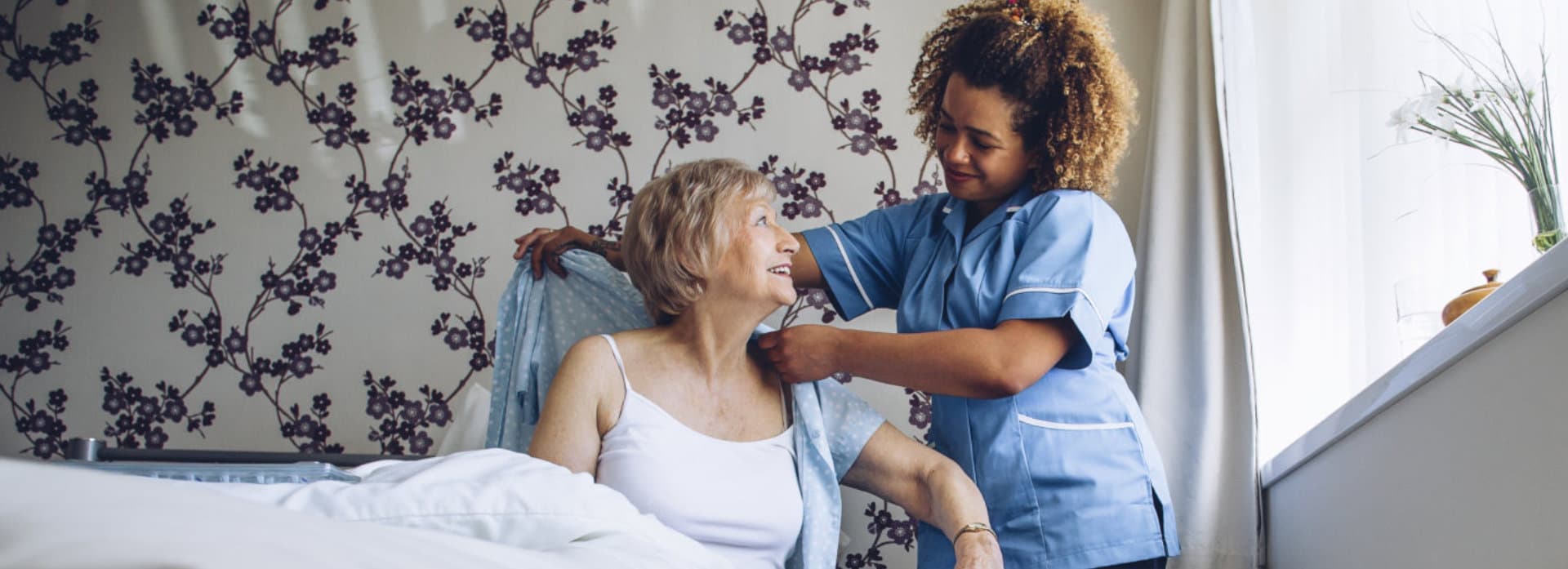 female caregiver assisting senior woman