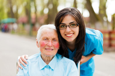 senior woman and female caregiver smiling