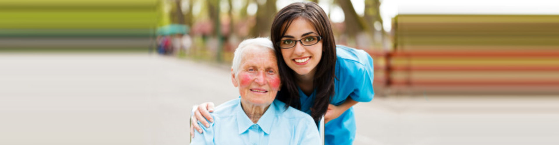 senior woman and female caregiver smiling