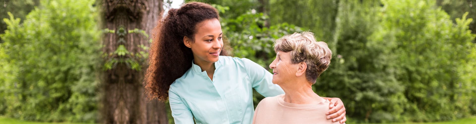 female caregiver and senior woman looking at each other