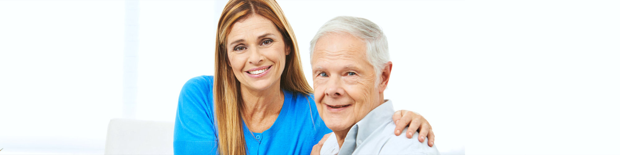 female caregiver and senior man smiling